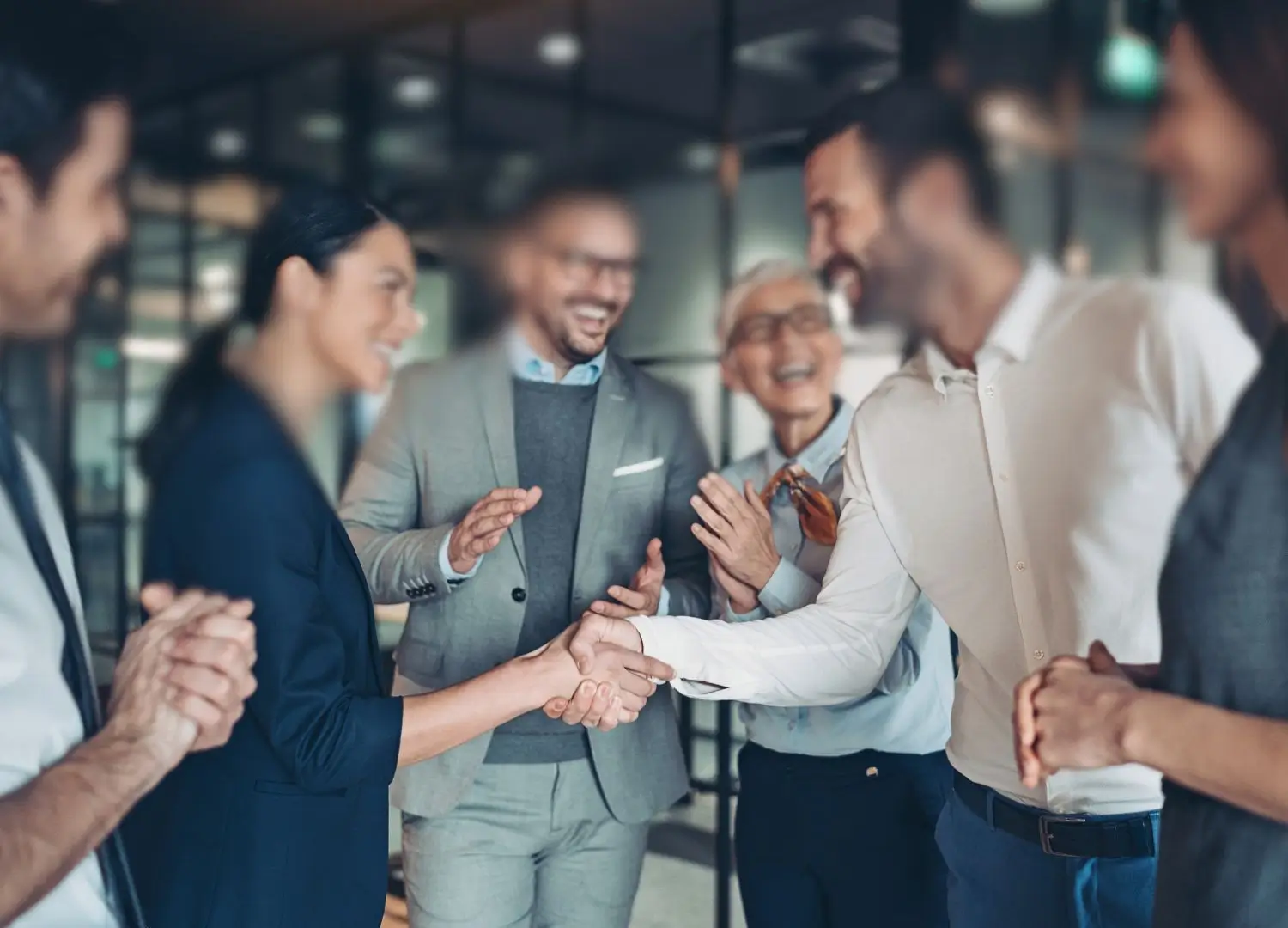 a group of business people shaking hands in an office