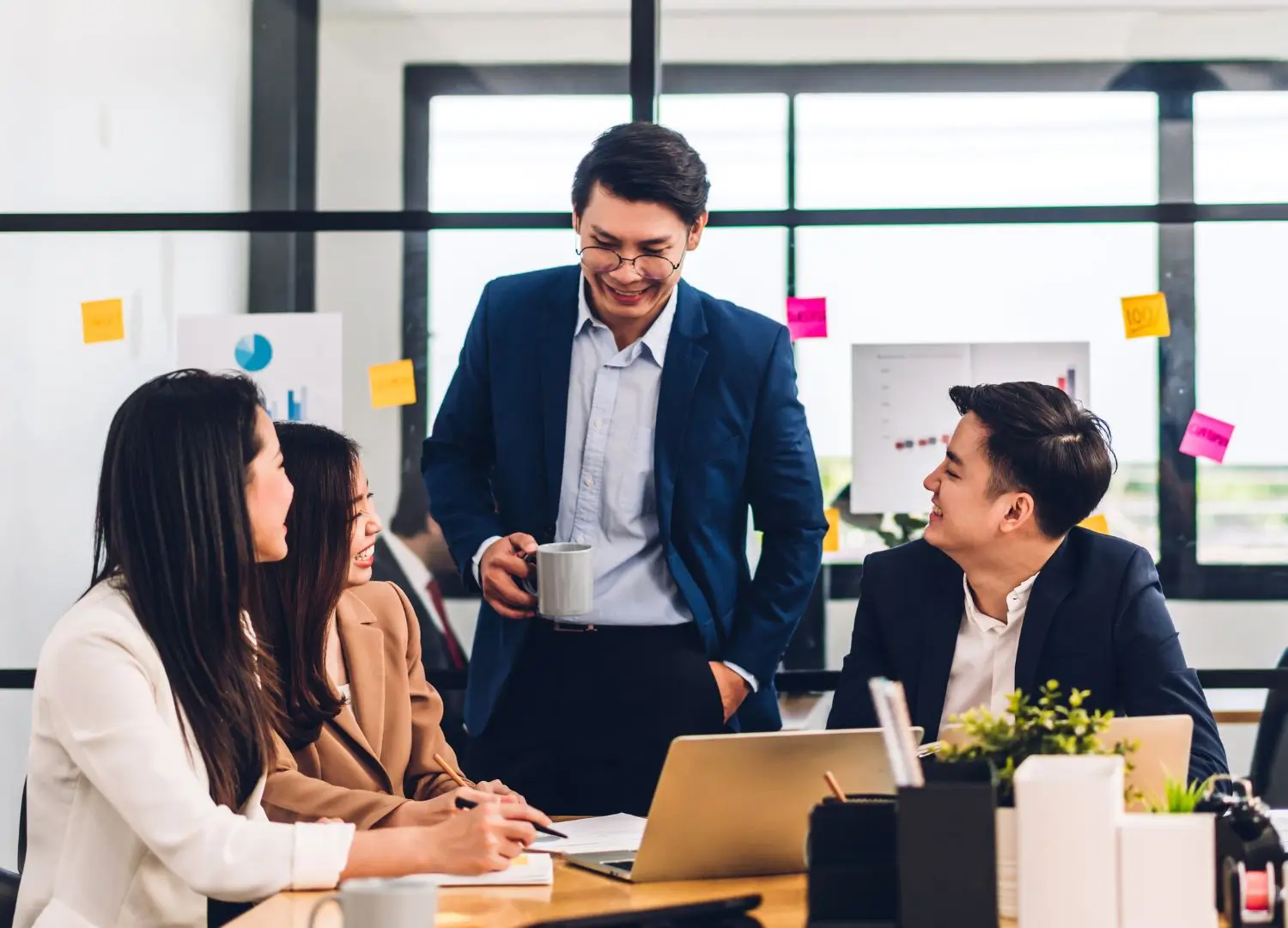 a group of people sitting around a table in an office